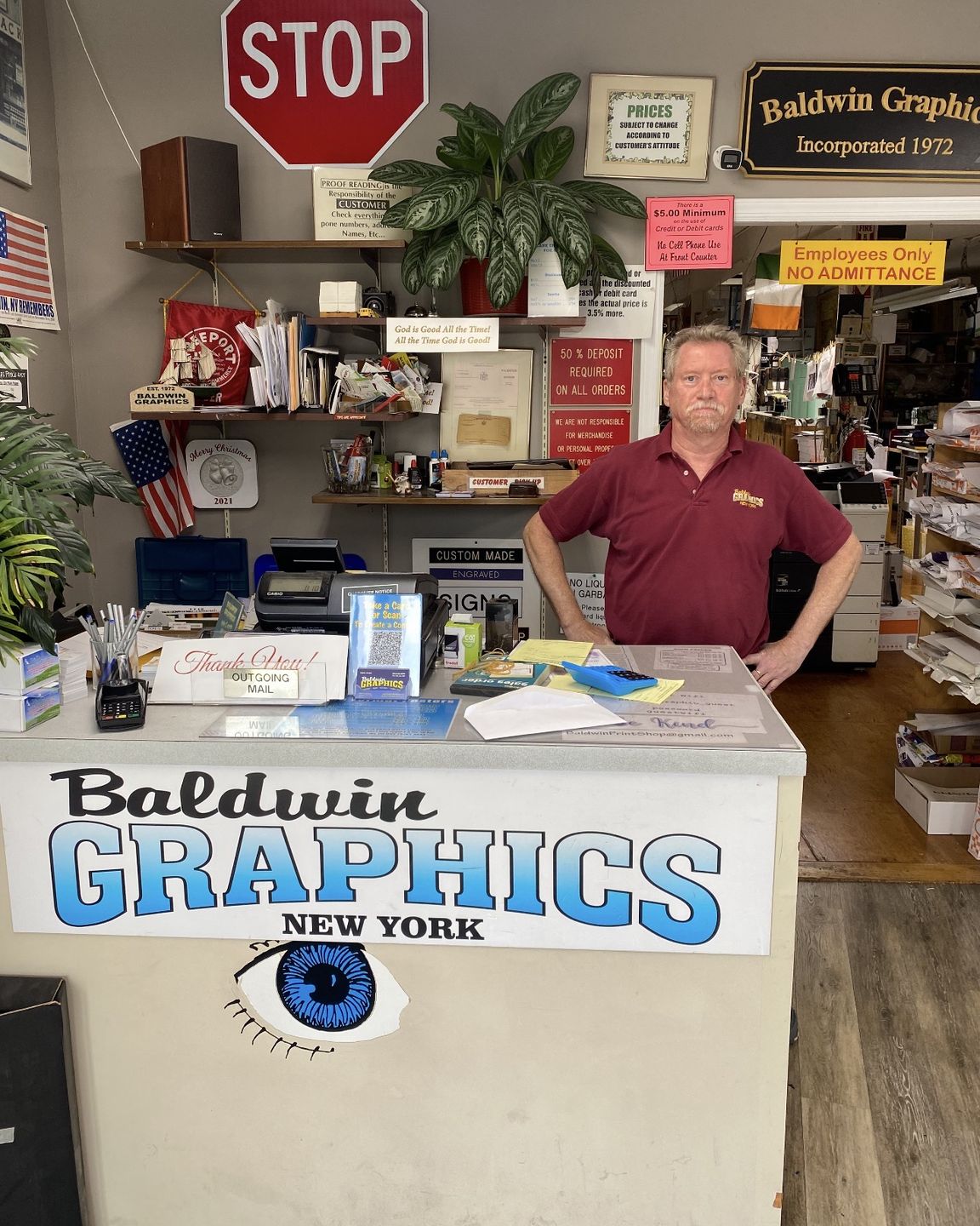 Robert behind the counter at Baldwin Graphics on Grand Avenue